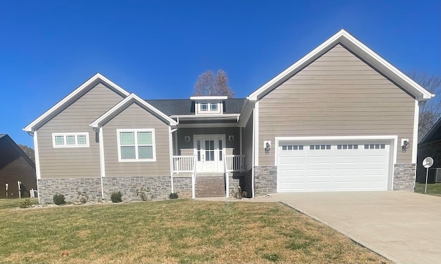 craftsman-style home with covered porch, a garage, and a front lawn