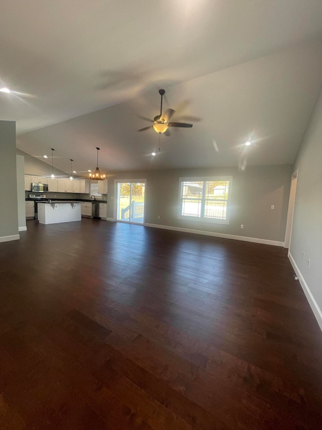 unfurnished living room featuring lofted ceiling, ceiling fan, and dark hardwood / wood-style flooring