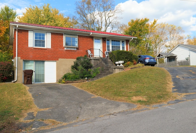 view of front of house featuring a garage and a front lawn