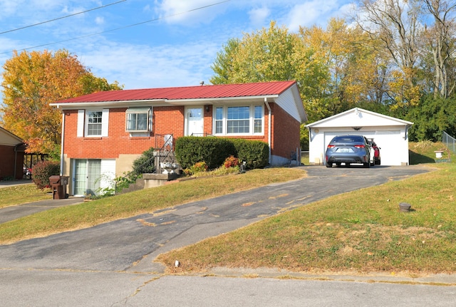 view of front of home with a front lawn, a garage, and an outdoor structure