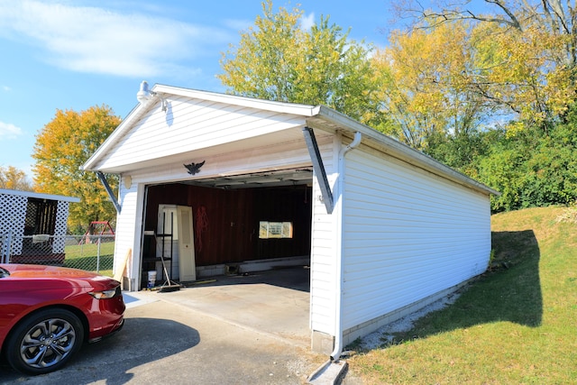 view of side of property with a garage and an outdoor structure