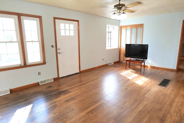 foyer entrance featuring ceiling fan and dark hardwood / wood-style floors