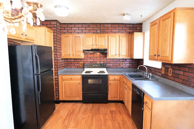 kitchen with light wood-type flooring, a textured ceiling, sink, and black appliances