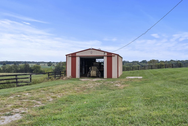 view of outbuilding featuring a lawn and a rural view