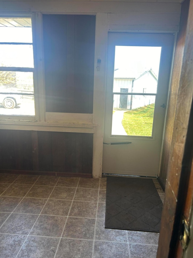 doorway featuring wooden walls