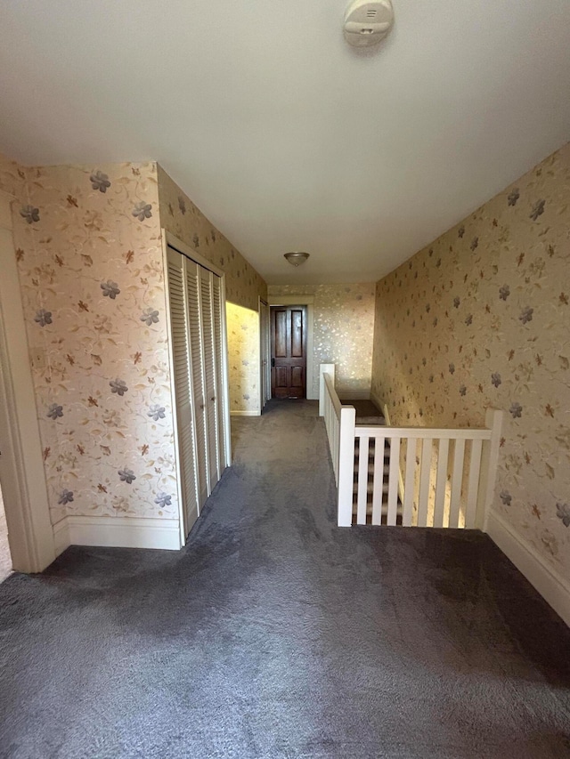 corridor with dark colored carpet