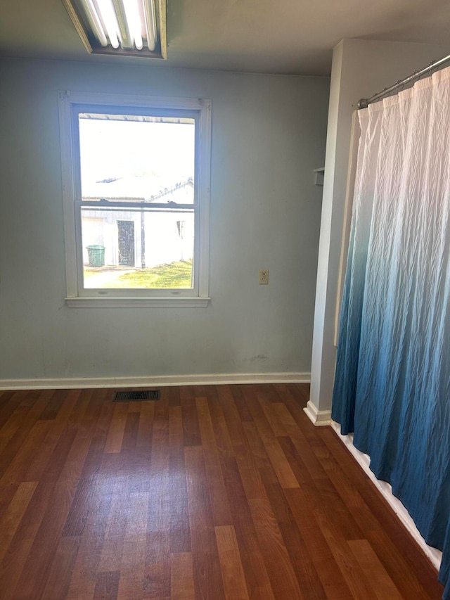 spare room featuring dark hardwood / wood-style flooring