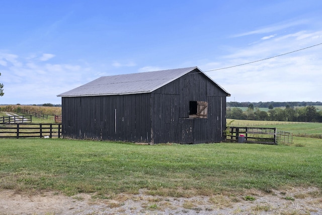 view of outbuilding with a yard and a rural view