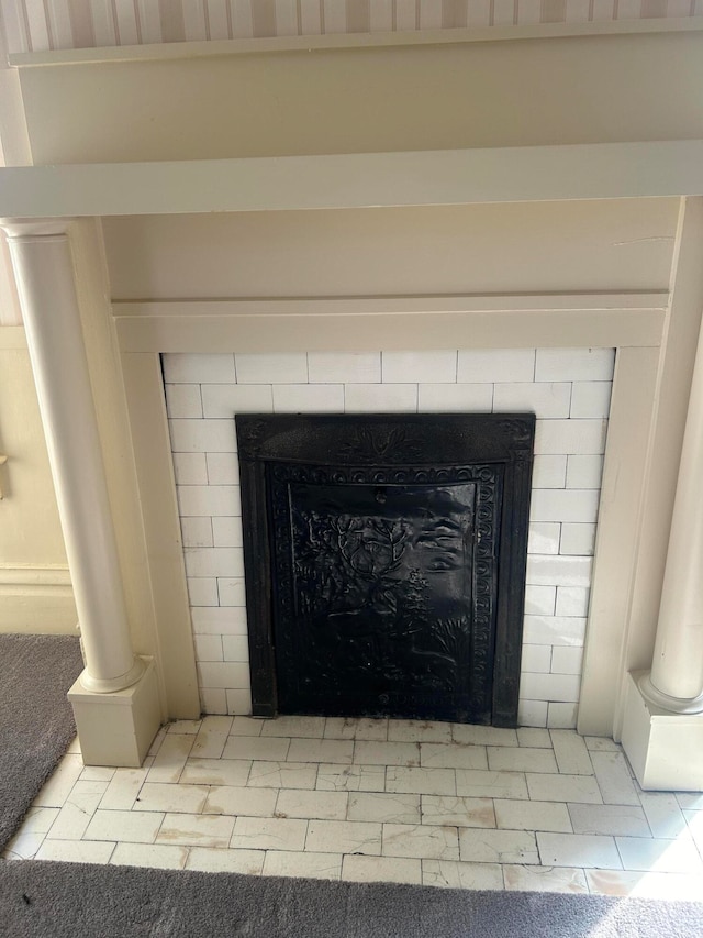 details featuring a tile fireplace and tile patterned flooring