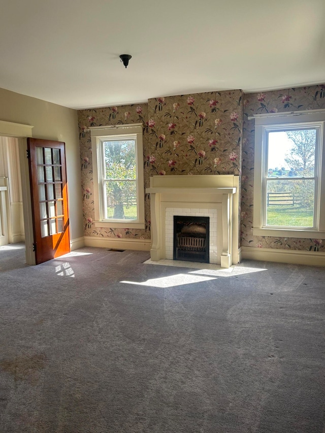 unfurnished living room featuring carpet flooring and a fireplace