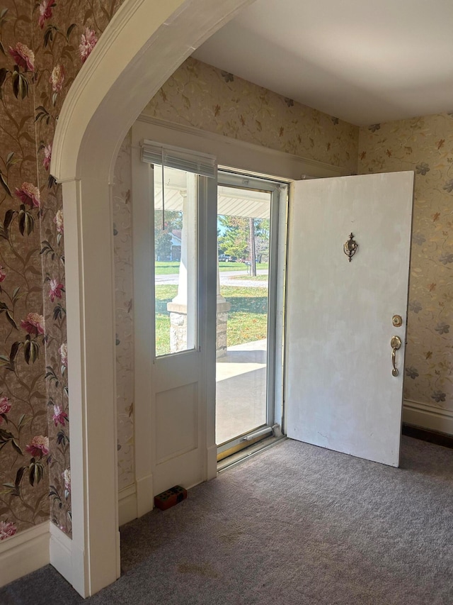 entryway featuring dark carpet