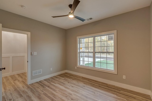 spare room featuring light wood-type flooring and ceiling fan