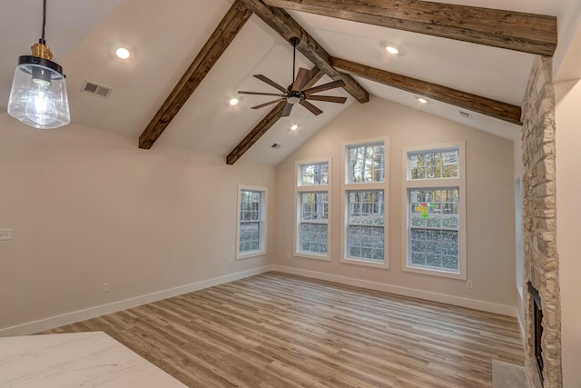 interior space featuring beamed ceiling, light hardwood / wood-style flooring, and ceiling fan