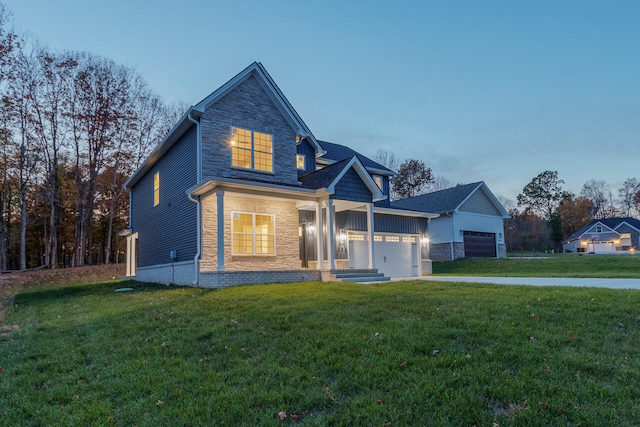 view of front of home with a lawn and a garage