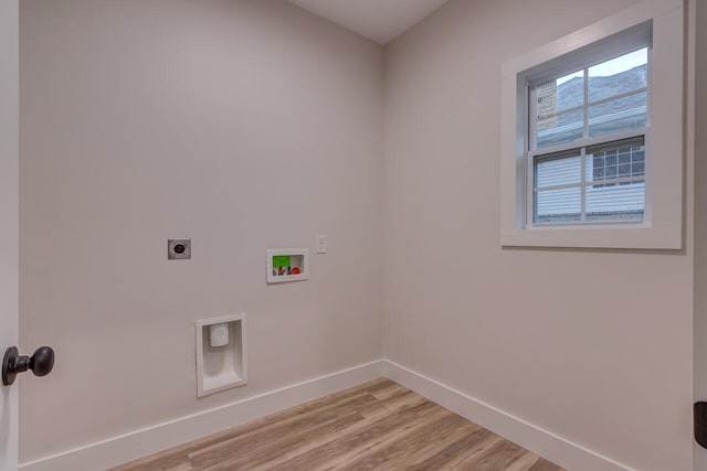 clothes washing area featuring hookup for a washing machine, light hardwood / wood-style floors, and electric dryer hookup