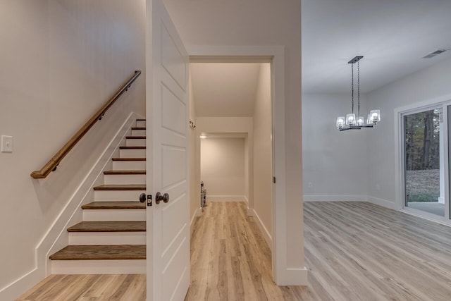 staircase with hardwood / wood-style flooring