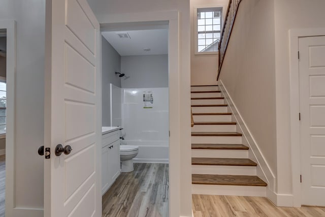 stairway with wood-type flooring