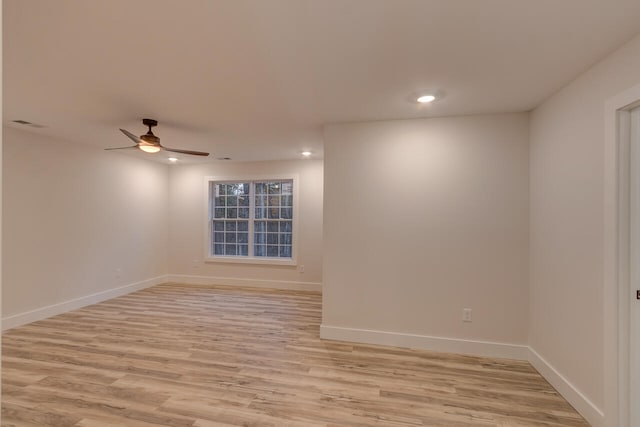 empty room with ceiling fan and light wood-type flooring