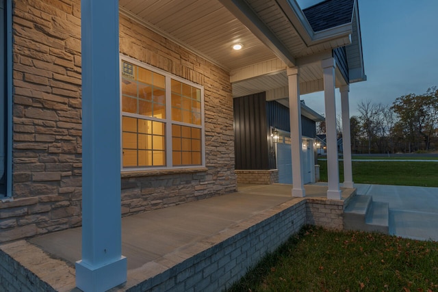 patio terrace at dusk featuring covered porch