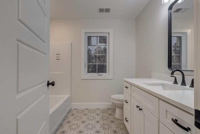 bathroom with vanity, toilet, and a washtub