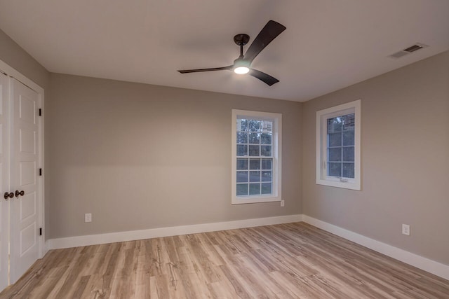 empty room with light hardwood / wood-style floors and ceiling fan