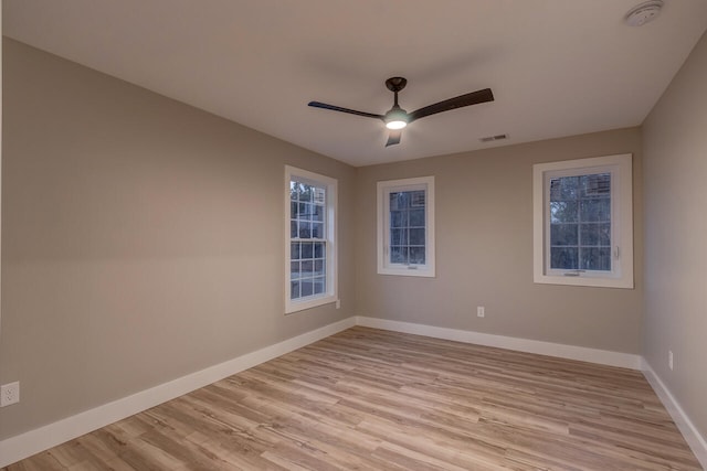 spare room with light wood-type flooring and ceiling fan