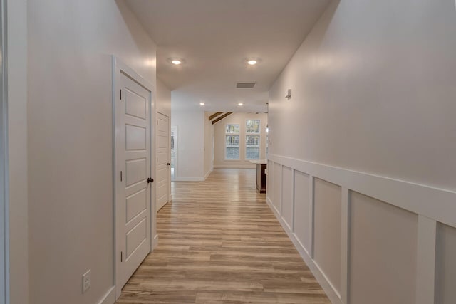 corridor with light wood-type flooring