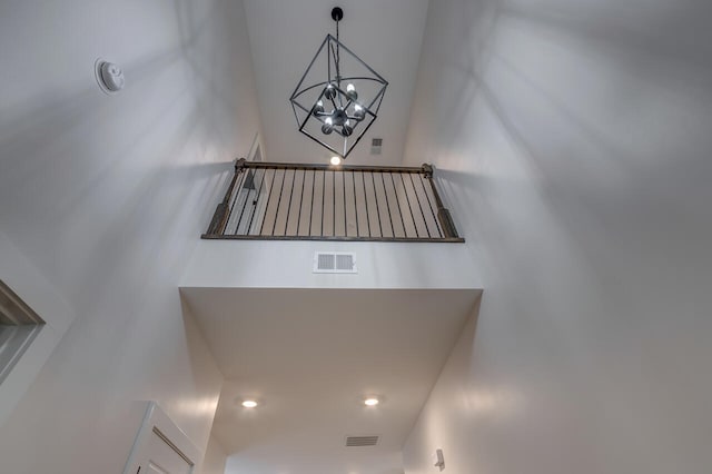 stairs featuring a chandelier