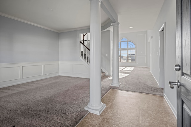 entrance foyer featuring ornamental molding and carpet flooring