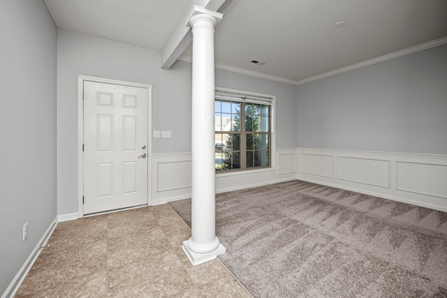 foyer entrance with ornate columns, carpet, and ornamental molding