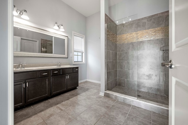 bathroom featuring vanity, a tile shower, and tile patterned floors