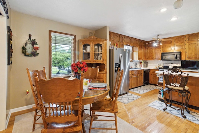 kitchen featuring backsplash, sink, stainless steel fridge, light hardwood / wood-style floors, and ceiling fan