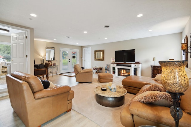 living room featuring french doors and light hardwood / wood-style floors