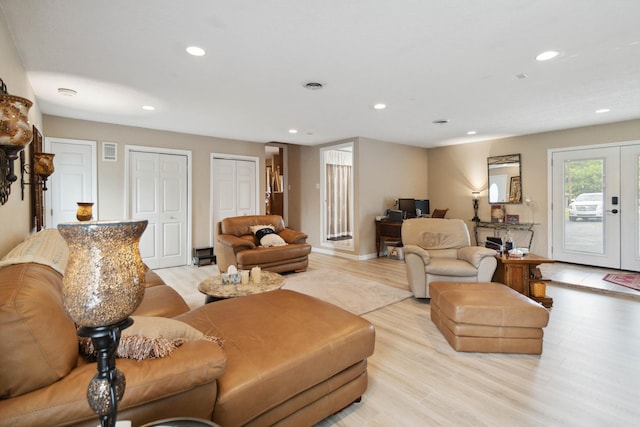 living room with french doors and light hardwood / wood-style floors