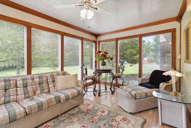 sunroom featuring ceiling fan