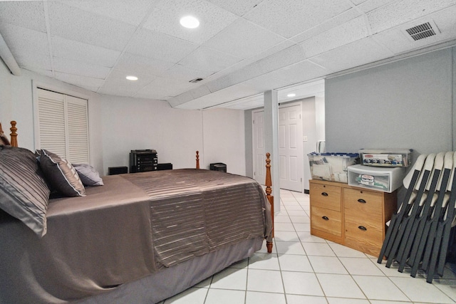 tiled bedroom with a paneled ceiling