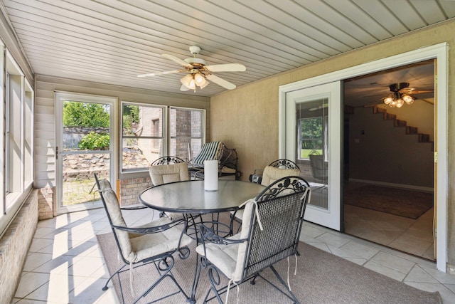 sunroom / solarium featuring wooden ceiling and ceiling fan