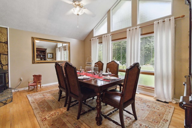 dining room featuring lofted ceiling, light hardwood / wood-style flooring, and ceiling fan