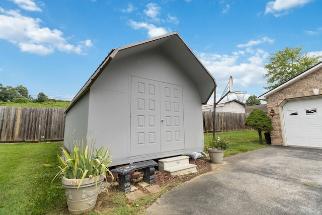 view of outdoor structure featuring a yard and a garage