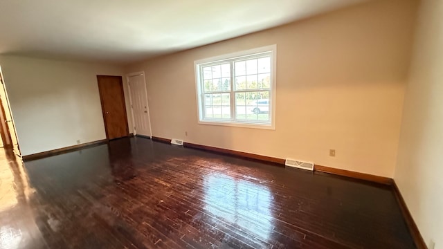 empty room with dark hardwood / wood-style floors