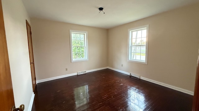 spare room featuring dark wood-type flooring