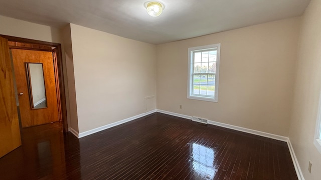 unfurnished room with dark hardwood / wood-style floors