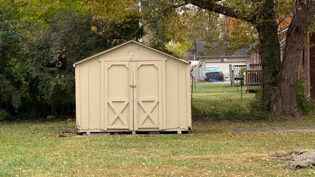 view of outbuilding featuring a yard