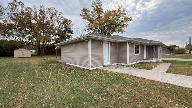 exterior space with a storage unit and a front lawn