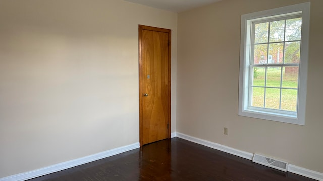 spare room featuring dark hardwood / wood-style flooring