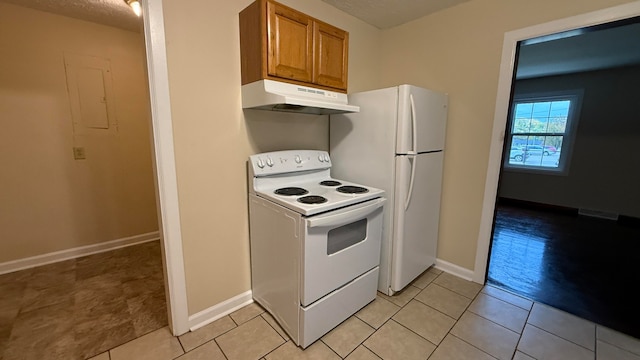 kitchen featuring white electric range oven, a textured ceiling, and light tile patterned floors