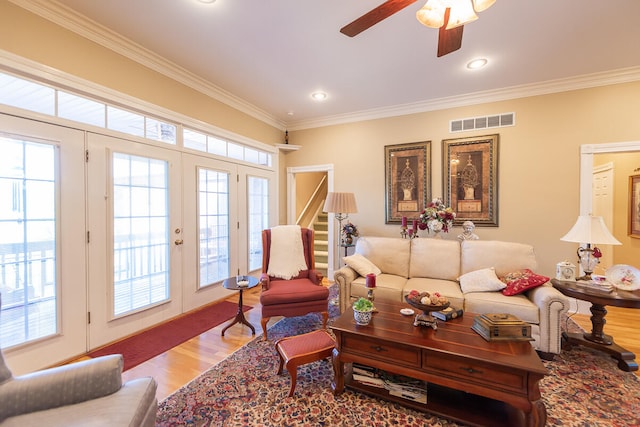 living room featuring french doors, ceiling fan, wood-type flooring, and ornamental molding