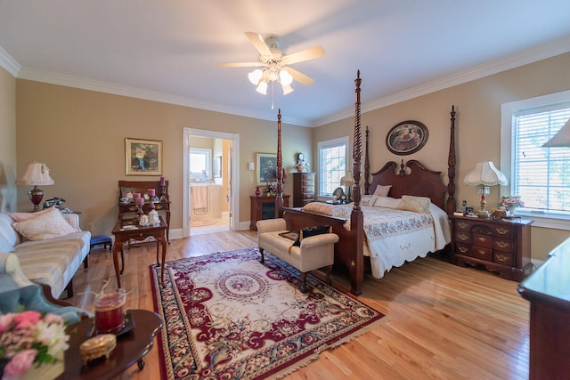 bedroom with ornamental molding, ceiling fan, multiple windows, and hardwood / wood-style flooring