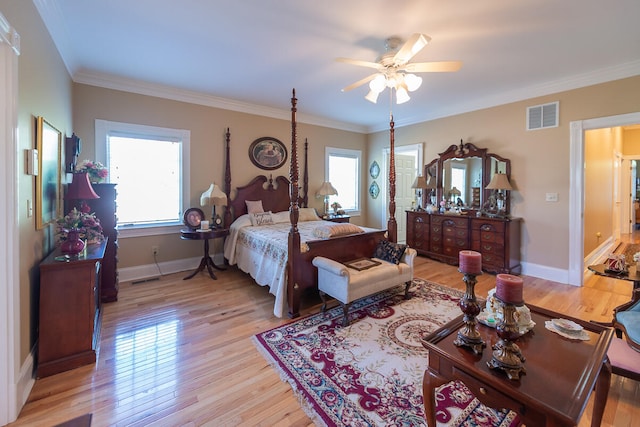 bedroom featuring light hardwood / wood-style floors, ornamental molding, multiple windows, and ceiling fan