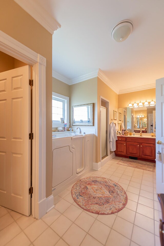 bathroom with vanity, ornamental molding, shower with separate bathtub, and tile patterned floors